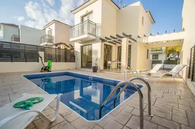 a swimming pool in the backyard of a house at Protaras Allium Villa in Protaras
