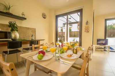 a dining room with a table with fruit on it at Protaras Allium Villa in Protaras