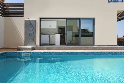a swimming pool in front of a house at Villa Royal View in Protaras