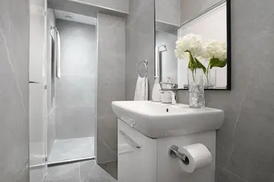 a bathroom with a sink and a vase of flowers at Villa Royal View in Protaras