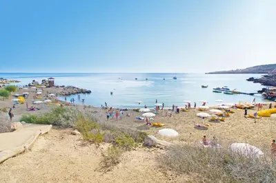 a group of people on a beach with the water at Villa Royal View in Protaras