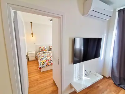 a living room with a television and a couch at CityCenter Boutique Apartment in Larnaka