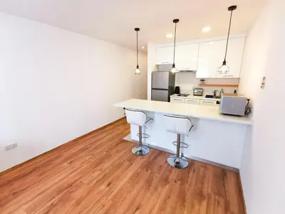 a kitchen with a counter and two stools at CityCenter Boutique Apartment in Larnaka