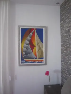 a painting of a sail boat on a wall at Marina Apartments 211 in Larnaka