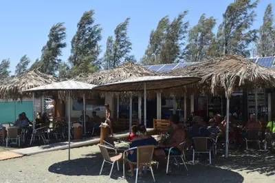 a group of people sitting in chairs under umbrellas at MERSINERA Paradise Garden NOAH HOUSE in Kivisil