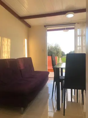 a living room with a couch and a table at MERSINERA Paradise Garden NOAH HOUSE in Kivisil