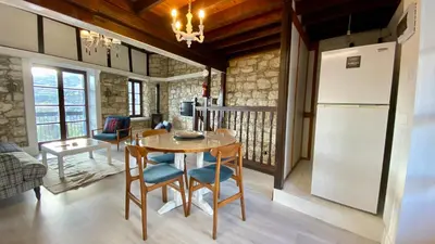 a kitchen and dining room with a table and a refrigerator at Leonys House by TrulyCyprus in Doros