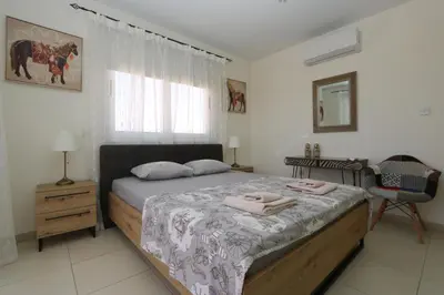 a bedroom with a bed with two towels on it at NISSI 3 VIEW HOLIDAY 2 BEDROOM APARTMENT in Ayia Napa