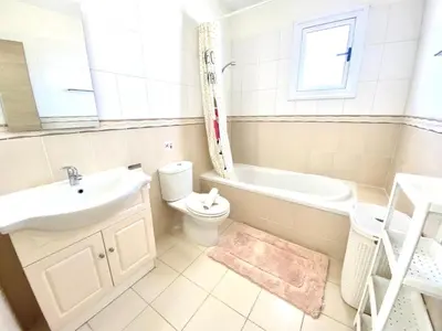 a bathroom with a sink and a toilet and a bath tub at NISSI 3 VIEW HOLIDAY 2 BEDROOM APARTMENT in Ayia Napa