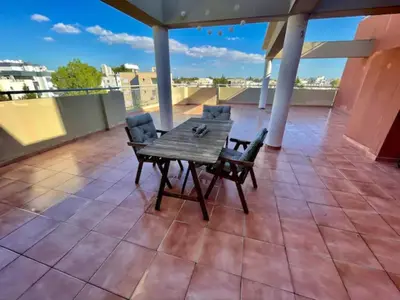 a wooden table and chairs on a roof at 3Bdr in Nicosia in Strovolos