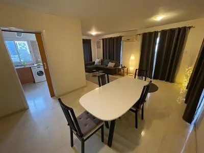 a living room with a white table and chairs at 3Bdr in Nicosia in Strovolos