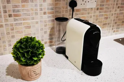 a toaster sitting on a counter next to a plant at Pretty and quiet studio, with wifi and parking in Limassol