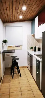 a kitchen with a stool in the middle of a kitchen at Pretty and quiet studio, with wifi and parking in Limassol