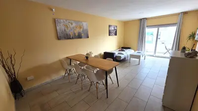 a living room with a wooden table and chairs at Spacious Lightflooded 2BR Apt / Near Center & Harbour in Larnaka
