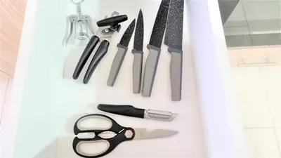 a bunch of knives and scissors hanging on a wall at Spacious Lightflooded 2BR Apt / Near Center & Harbour in Larnaka