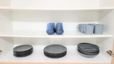a row of black plates on a shelf at Spacious Lightflooded 2BR Apt / Near Center & Harbour in Larnaka