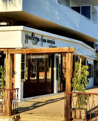 a store front with its doors open on a street at KALIDONIA RESIDENCE Suite Nicosia , Spacious 2 BR suite with office in Nicosia