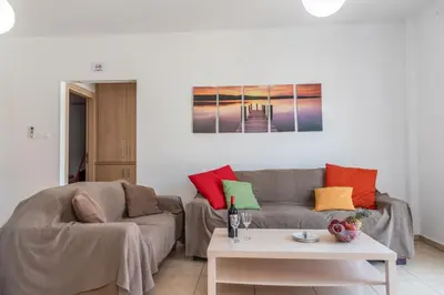 a living room with a couch and a table at Mythical Sands Resort & Spa, Evilion Apartment in Paralimni