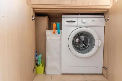 a washer and dryer in a small room at Mythical Sands Resort & Spa, Evilion Apartment in Paralimni