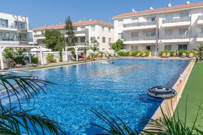 a large swimming pool in front of a building at Mythical Sands Resort & Spa, Evilion Apartment in Paralimni
