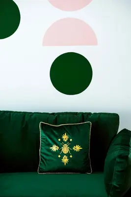 a green couch with a pillow with a spider on it at New Leventis Luxury Κing Suite 41-Central Location in Ayia Napa