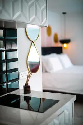 a lamp sitting on a table in a bedroom at New Leventis Luxury Κing Suite 41-Central Location in Ayia Napa