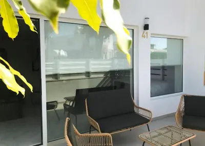 a room with chairs and a window and a table at New Leventis Luxury Κing Suite 41-Central Location in Ayia Napa