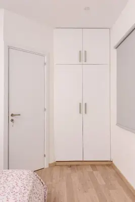 two wardrobes in a bedroom with white walls at Valdivian Flat 18 in Larnaka