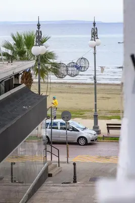 a car parked in a parking lot next to the beach at Valdivian Flat 18 in Larnaka