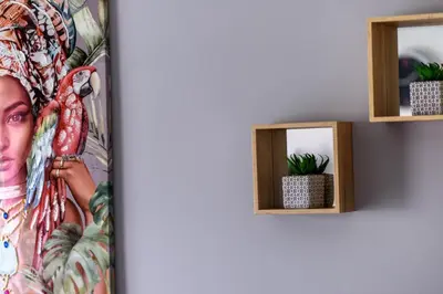 a picture of a woman on a wall with a mirror at Valdivian Flat 18 in Larnaka