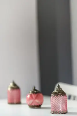 three red candlesticks sitting on top of a table at Valdivian Flat 18 in Larnaka
