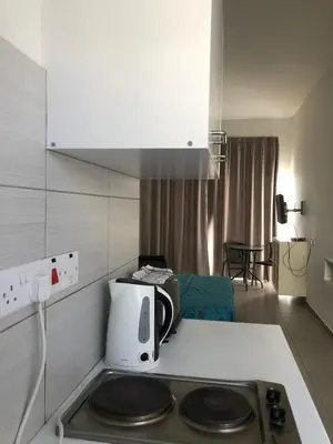 a kitchen with a microwave and a stove top oven at Sunny holiday by konnos in Paralimni