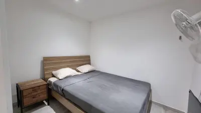 a small bedroom with a bed and a night stand at Nagia’s Apartment in Kakopetria