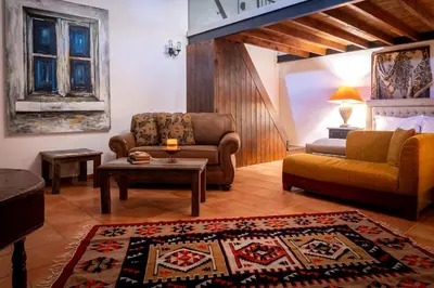 a living room with a couch and a coffee table at Oinoessa Traditional Boutique Guest Houses in Lofou