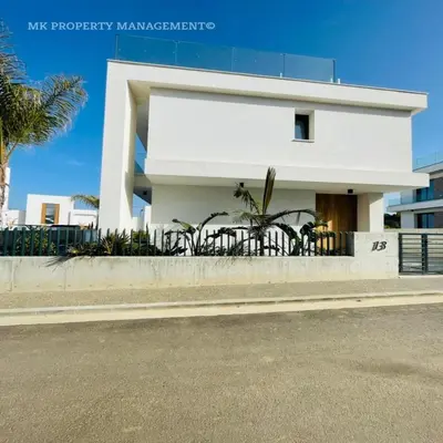 a white house on the side of a street at By the Beach Villa Natalya in Protaras