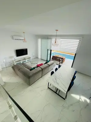 a living room with a couch and a table at By the Beach Villa Natalya in Protaras