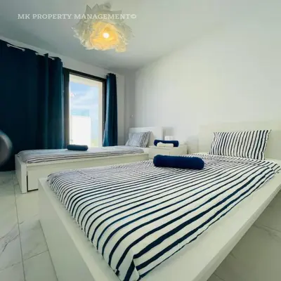 two beds sitting next to each other in a bedroom at By the Beach Villa Natalya in Protaras