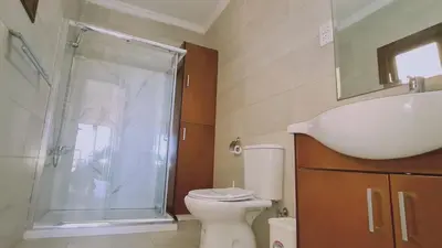 a bathroom with a shower and a toilet and a sink at STAY Ocean View Villa in Paralimni