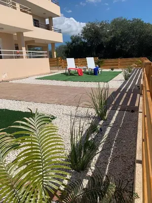 a patio of a house with a bench and plants at Nissi3 B1 Lovely 1Bdr Ground Floor Apartment near Nissi Beach. in Ayia Napa