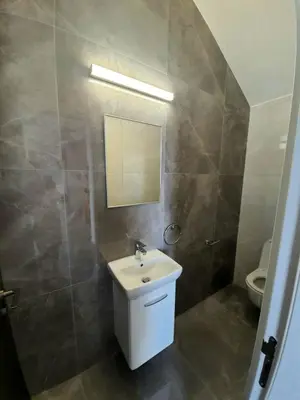 a bathroom with a sink and a mirror and a toilet at Hanna Panorama Villa in Protaras