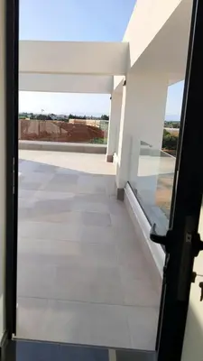 an open door to a room with a view of a building at Hanna Panorama Villa in Protaras