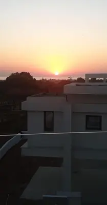 a sunset from the top of a building with a house at Hanna Panorama Villa in Protaras