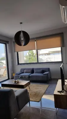 a living room with a couch and a table at Hanna Panorama Villa in Protaras