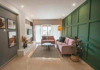 a living room with a couch and a table at The Green Apartment in Larnaka