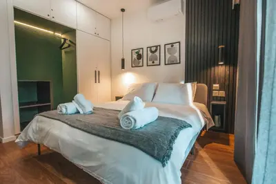 a bedroom with a bed with two pillows on it at The Green Apartment in Larnaka
