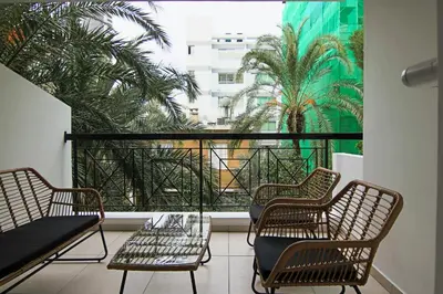 a balcony with chairs and a large window with palm trees at Phaedrus Living City View Luxury Iras Flat 102 in Nicosia