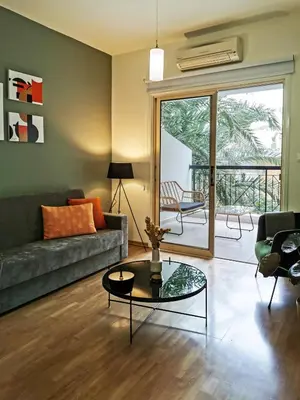 a living room with a couch and a glass table at Phaedrus Living City View Luxury Iras Flat 102 in Nicosia