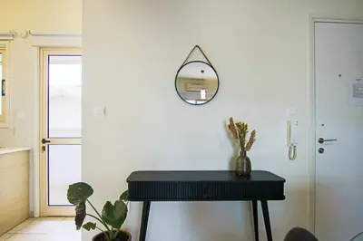 a black piano in a room with a mirror at Phaedrus Living City View Luxury Iras Flat 102 in Nicosia