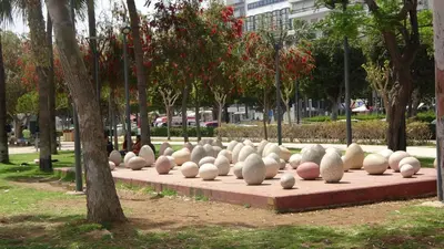 a row of white sculptures sitting on a sidewalk at Antonakis 501 in Limassol