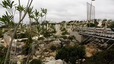 a bridge over a garden with trees and plants at Antonakis 501 in Limassol